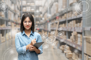 woman-holding-tablet-and-stylus-in-warehouse-with-cardboard-boxes-on-shelves-and-digital-overlay-of-online-shopping-icons