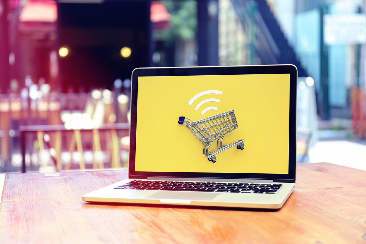 open-laptop-with-yellow-screen-and-shopping-cart-icon