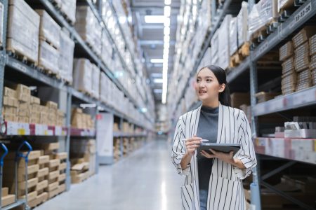 retail merchant pool concept; asian woman business owner using digital tablet checking amount of stock product inventory on shelf at distribution warehouse factory
